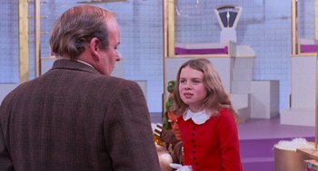 Movie still from “Willy Wonka & the Chocolate Factory” (1971), directed by Mel Stuart – An older man and a young girl talking to each other; Medium shot, Over the shoulder angle