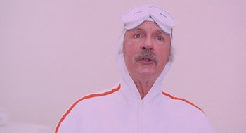 Movie still from “Willy Wonka & the Chocolate Factory” (1971), directed by Mel Stuart – A man in a white jacket and goggles; Close Up shot, Low angle