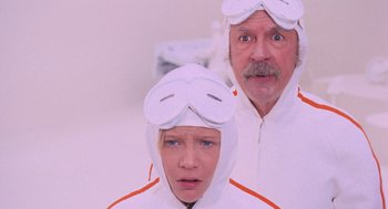 Movie still from “Willy Wonka & the Chocolate Factory” (1971), directed by Mel Stuart – A man and a woman wearing white pajamas and goggles; Medium shot, Low angle