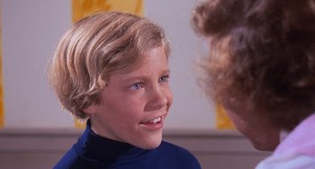 Movie still from “Willy Wonka & the Chocolate Factory” (1971), directed by Mel Stuart – A young boy with blonde hair talking to an older woman; Close Up shot, Over the shoulder angle