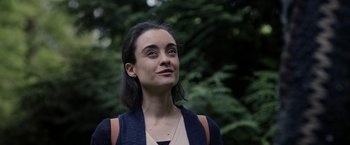 Movie still from “Winnie the Pooh: Blood and Honey” (2023), directed by Rhys Frake-Waterfield – A woman standing in front of a forest; Close Up shot, Low angle