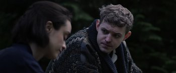 Movie still from “Winnie the Pooh: Blood and Honey” (2023), directed by Rhys Frake-Waterfield – A man in a sweater is looking at another man in a sweater; Close Up shot, Over the shoulder angle