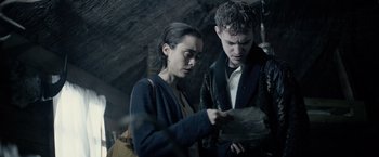 Movie still from “Winnie the Pooh: Blood and Honey” (2023), directed by Rhys Frake-Waterfield – A man and a woman looking at a piece of paper; Medium shot, Low angle