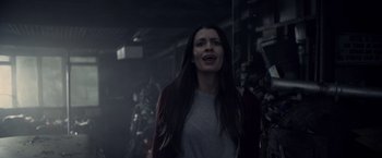 Movie still from “Winnie the Pooh: Blood and Honey” (2023), directed by Rhys Frake-Waterfield – A woman standing in a dark room with her mouth wide open; Close Up shot, Low angle