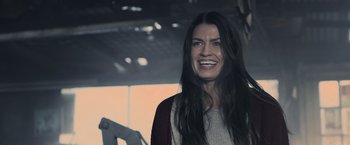 Movie still from “Winnie the Pooh: Blood and Honey” (2023), directed by Rhys Frake-Waterfield – A woman with long black hair smiling for the camera; Close Up shot, Low angle