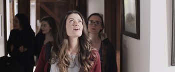 Movie still from “Winnie the Pooh: Blood and Honey” (2023), directed by Rhys Frake-Waterfield – A woman looking up at the sky while standing next to another woman; Medium shot, Low angle