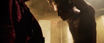 Movie still from “Winnie the Pooh: Blood and Honey” (2023), directed by Rhys Frake-Waterfield – A person in a room near a window; Close Up shot, Low angle