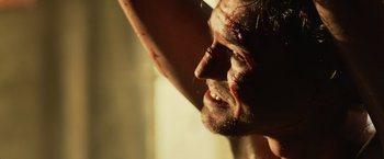 Movie still from “Winnie the Pooh: Blood and Honey” (2023), directed by Rhys Frake-Waterfield – A man's face covered in blood; Extreme Close Up shot, Over the shoulder angle