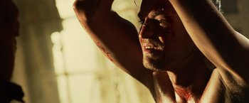 Movie still from “Winnie the Pooh: Blood and Honey” (2023), directed by Rhys Frake-Waterfield – A person with blood all over his face; Extreme Close Up shot, Over the shoulder angle