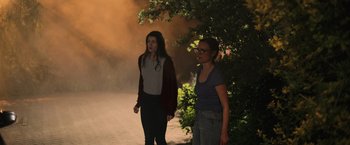 Movie still from “Winnie the Pooh: Blood and Honey” (2023), directed by Rhys Frake-Waterfield – Two women walking down the street at night; Wide shot, Over the shoulder angle