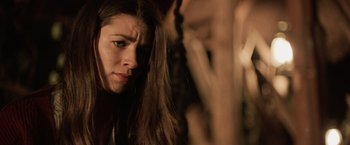 Movie still from “Winnie the Pooh: Blood and Honey” (2023), directed by Rhys Frake-Waterfield – A person with long brown hair; Close Up shot, Low angle