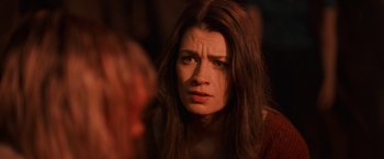 Movie still from “Winnie the Pooh: Blood and Honey” (2023), directed by Rhys Frake-Waterfield – A person with long brown hair; Close Up shot, Over the shoulder angle