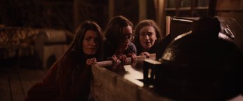 Movie still from “Winnie the Pooh: Blood and Honey” (2023), directed by Rhys Frake-Waterfield – A group of people standing next to each other; Medium shot, Low angle