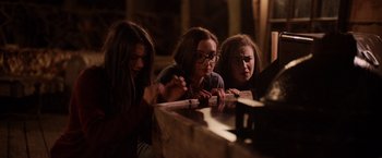 Movie still from “Winnie the Pooh: Blood and Honey” (2023), directed by Rhys Frake-Waterfield – A group of people sitting at a table; Medium shot, High angle