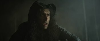 Movie still from “Winnie the Pooh: Blood and Honey” (2023), directed by Rhys Frake-Waterfield – A person with long curly hair; Close Up shot, Low angle