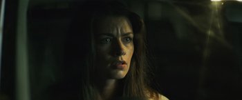 Movie still from “Winnie the Pooh: Blood and Honey” (2023), directed by Rhys Frake-Waterfield – A person with long brown hair; Close Up shot, Low angle