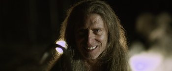 Movie still from “Winnie the Pooh: Blood and Honey” (2023), directed by Rhys Frake-Waterfield – A person with long hair; Close Up shot, Low angle