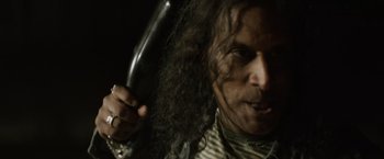 Movie still from “Winnie the Pooh: Blood and Honey” (2023), directed by Rhys Frake-Waterfield – A person holding a hair brush; Close Up shot, Low angle