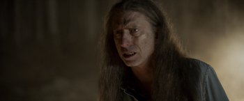 Movie still from “Winnie the Pooh: Blood and Honey” (2023), directed by Rhys Frake-Waterfield – A person with long brown hair; Close Up shot, Over the shoulder angle