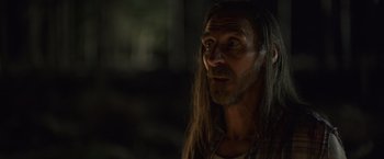 Movie still from “Winnie the Pooh: Blood and Honey” (2023), directed by Rhys Frake-Waterfield – A person with long hair; Close Up shot, Over the shoulder angle