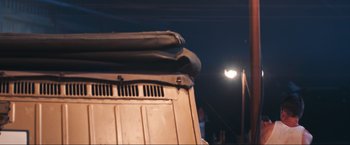 Movie still from “Wolf Hound” (2022), directed by Michael B. Chait – The back of a truck at night; Medium shot, Low angle