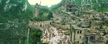 Movie still from “Wonder Woman” (2017), directed by Patty Jenkins – A group of people standing in a courtyard with mountains in the background; Extreme Wide shot, High angle