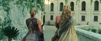 Movie still from “Wonder Woman” (2017), directed by Patty Jenkins – A couple of people that are standing in the dirt; Medium shot, Over the shoulder angle