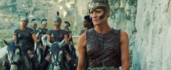 Movie still from “Wonder Woman” (2017), directed by Patty Jenkins – A group of people dressed in costumes and helmets; Medium shot, Over the shoulder angle
