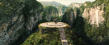 Movie still from “Wonder Woman” (2017), directed by Patty Jenkins – A man standing on top of a rock on top of a mountain; Extreme Wide shot, High angle