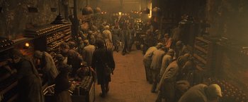 Movie still from “Wonder Woman” (2017), directed by Patty Jenkins – A group of people walking through a market area; Wide shot, High angle