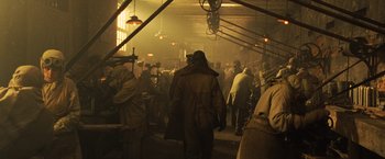 Movie still from “Wonder Woman” (2017), directed by Patty Jenkins – A group of people standing around in a room; Wide shot, High angle