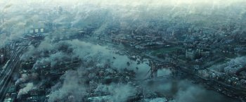 Movie still from “Wonder Woman” (2017), directed by Patty Jenkins – An aerial view of a river with a bridge in the middle of it; Extreme Wide shot, High angle