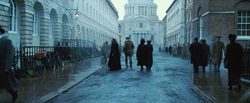 Movie still from “Wonder Woman” (2017), directed by Patty Jenkins – A group of people walking down a street; Wide shot, Low angle