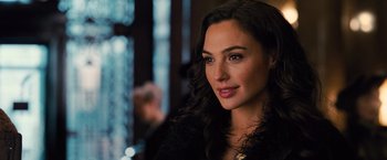 Movie still from “Wonder Woman” (2017), directed by Patty Jenkins – A person with long curly hair; Close Up shot, Over the shoulder angle