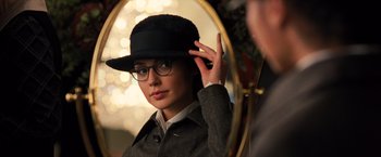 Movie still from “Wonder Woman” (2017), directed by Patty Jenkins – A woman wearing a hat and glasses in front of a mirror; Close Up shot, Over the shoulder angle