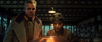 Movie still from “Wonder Woman” (2017), directed by Patty Jenkins – A man and a woman wearing military uniforms; Medium shot, Low angle