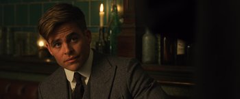 Movie still from “Wonder Woman” (2017), directed by Patty Jenkins – A man in a suit sitting in front of a candle; Close Up shot, Over the shoulder angle