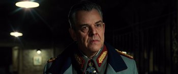 Movie still from “Wonder Woman” (2017), directed by Patty Jenkins – An older man wearing a military uniform; Close Up shot, Low angle