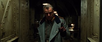 Movie still from “Wonder Woman” (2017), directed by Patty Jenkins – An older man in a military uniform is holding his hand up; Close Up shot, Low angle