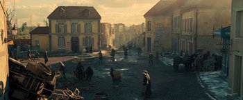 Movie still from “Wonder Woman” (2017), directed by Patty Jenkins – A group of people walking down a street; Extreme Wide shot, High angle