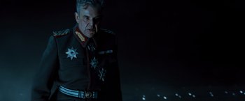 Movie still from “Wonder Woman” (2017), directed by Patty Jenkins – An older man in a military uniform looking at the camera; Close Up shot, Low angle