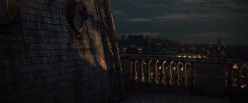 Movie still from “Wonder Woman” (2017), directed by Patty Jenkins – A view of a city at night from a balcony; Extreme Wide shot, High angle