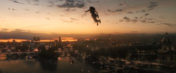 Movie still from “Wonder Woman” (2017), directed by Patty Jenkins – A man flying through the air while riding a skateboard; Extreme Wide shot, Low angle