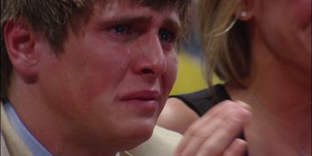 Movie still from “Woooooo! Becoming Ric Flair” (2022), directed by Ben Houser – A person with a crying look on his face; Extreme Close Up shot, High angle