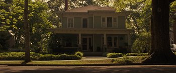 Movie still from “World War Z” (2013), directed by Marc Forster – A large house with a lot of bushes around it; Extreme Wide shot, High angle