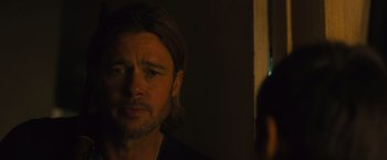 Movie still from “World War Z” (2013), directed by Marc Forster – A person with long hair looking at a mirror; Close Up shot, Over the shoulder angle
