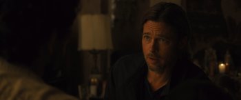 Movie still from “World War Z” (2013), directed by Marc Forster – A person sitting in front of a lamp; Close Up shot, Over the shoulder angle