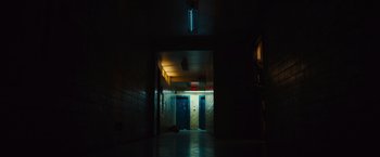 Movie still from “World War Z” (2013), directed by Marc Forster – A dark hallway with two blue doors in it; Extreme Wide shot, Low angle