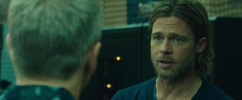 Movie still from “World War Z” (2013), directed by Marc Forster – A man talking to another man in front of a mirror; Close Up shot, Over the shoulder angle
