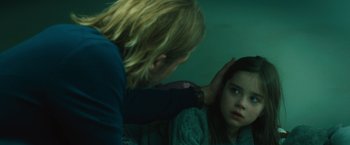Movie still from “World War Z” (2013), directed by Marc Forster – A young girl looking in the reflection of a mirror; Close Up shot, Over the shoulder angle